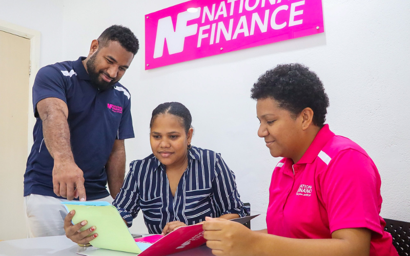 Blog Banner_Practical Finance Tips for Students and Parents: Managing School Loans in PNG_NF employees assisting a parent